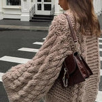 Gezellige kabeltrui voor dames met wijde mouwen, gebreid patroon en ontspannen pasvorm – perfect voor knusse winterdagen.