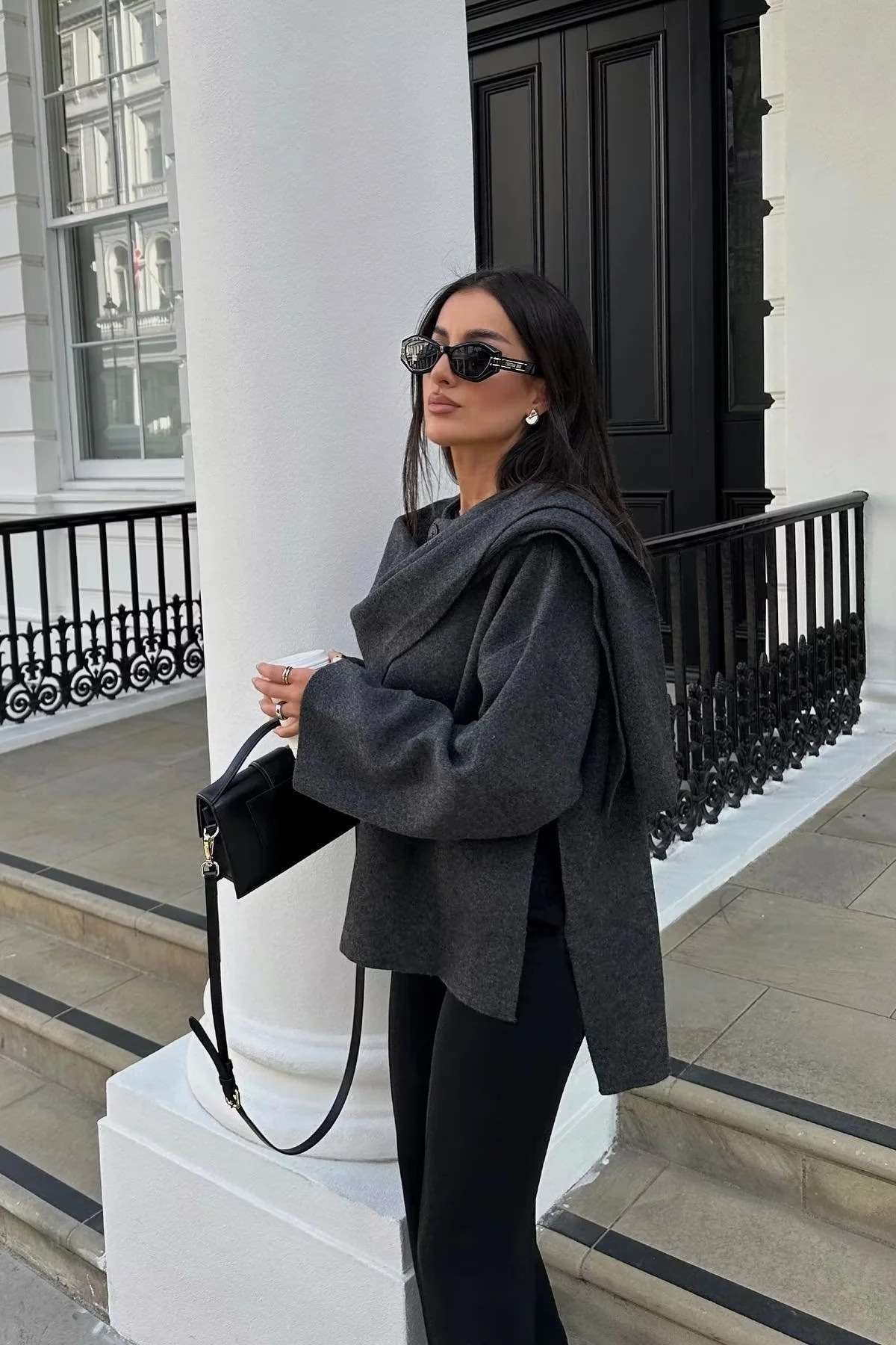 Elegante damesjas met gelaagde look en cape, perfect voor een chique en stijlvolle uitstraling.