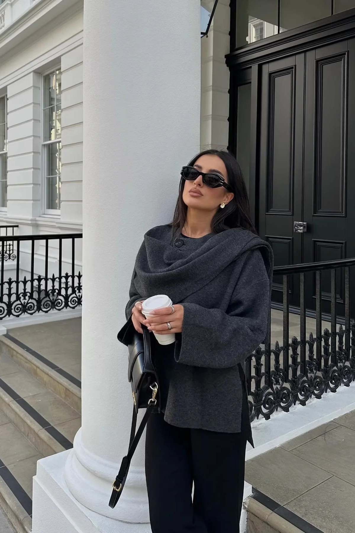 Elegante damesjas met gelaagde look en cape, perfect voor een chique en stijlvolle uitstraling.